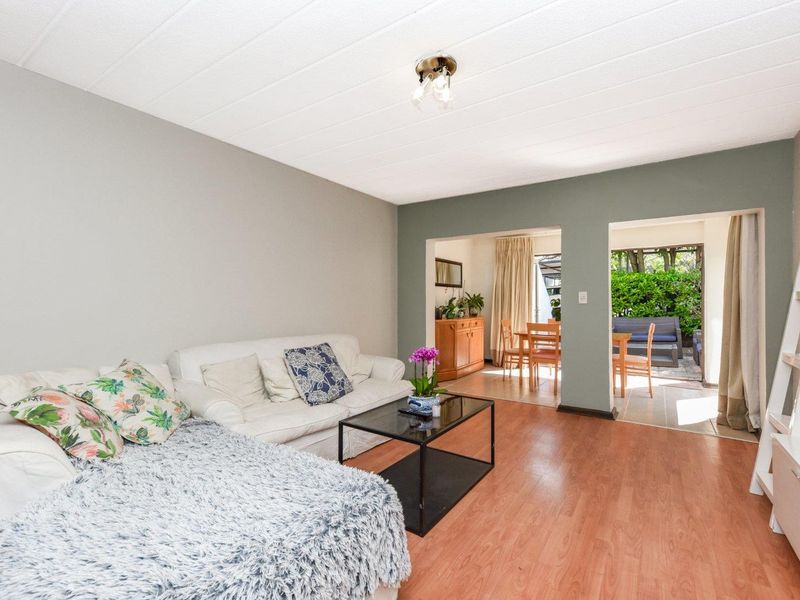 Open plan living area featuring laminate flooring and direct access to an outdoor patio space.