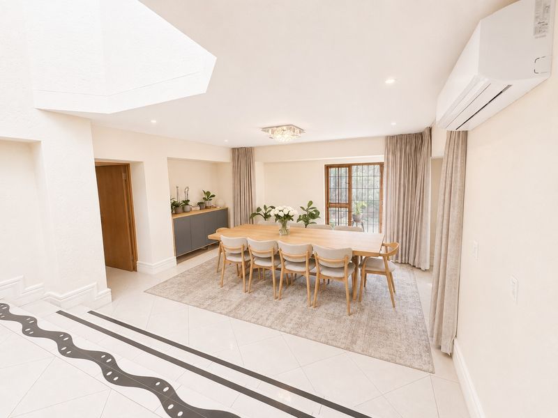 A bright and spacious dining area featuring tiled floors, recessed lighting, a wall-mounted air conditioning unit, and direct access to the outdoor space.