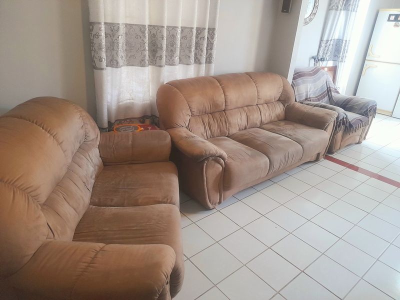 A living room area featuring neutral wall finishes and light-colored ceramic floor tiles.