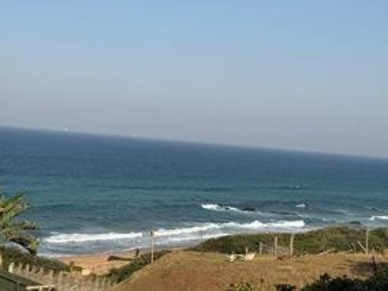 A scenic view of the ocean and coastline, showcasing the property's prime coastal location.