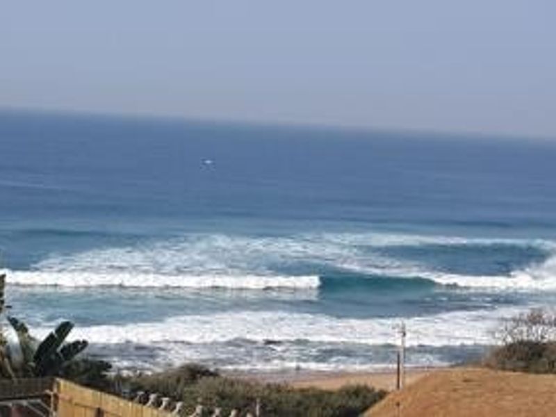 A scenic ocean view showcasing the coastline and breaking waves, providing a tranquil outlook from the property.