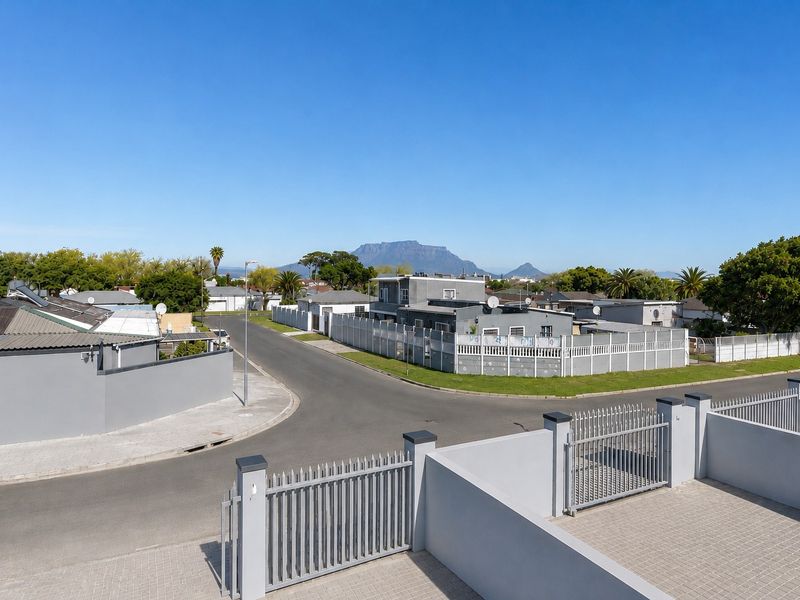 Elevated view overlooking the surrounding residential neighbourhood and streetscape, featuring clear views of Table Mountain in the distance.