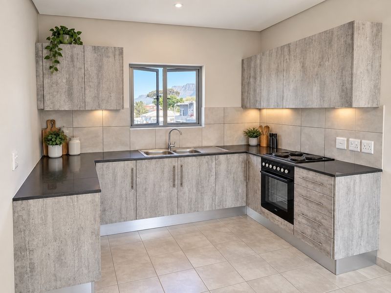 Modern kitchen featuring light wood-grain cabinetry, dark stone countertops, integrated electric oven and hob, and tiled backsplash with under-cabinet lighting.