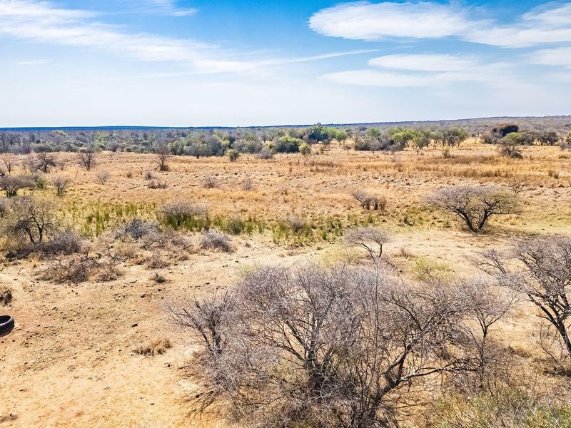 An aerial view of a large, undeveloped residential land plot featuring natural dry bushveld vegetation and open terrain.