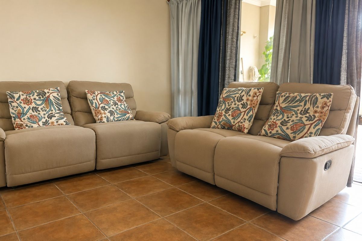 A living room area featuring ceramic tile flooring and a sliding glass door providing access to an outdoor space.