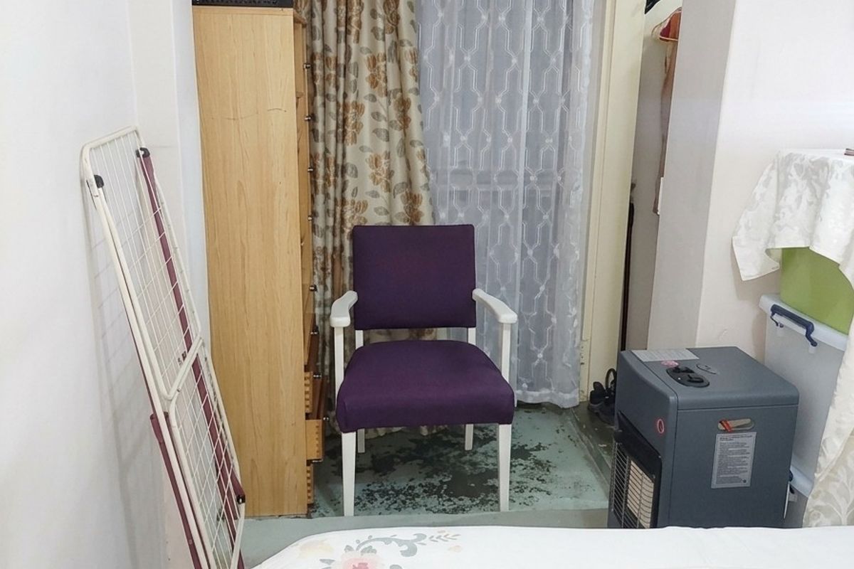 A bedroom featuring a recessed alcove area with built-in storage and access to an adjacent space.