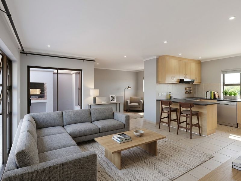 Modern open-plan living area featuring a well-appointed kitchen with light wood cabinetry, tiled floors, and seamless flow to an outdoor patio with a fireplace.