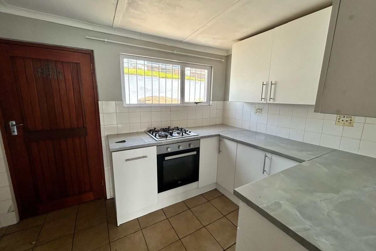 A functional kitchen featuring built-in cabinetry, a gas hob, an oven, tiled backsplash, and tiled flooring.