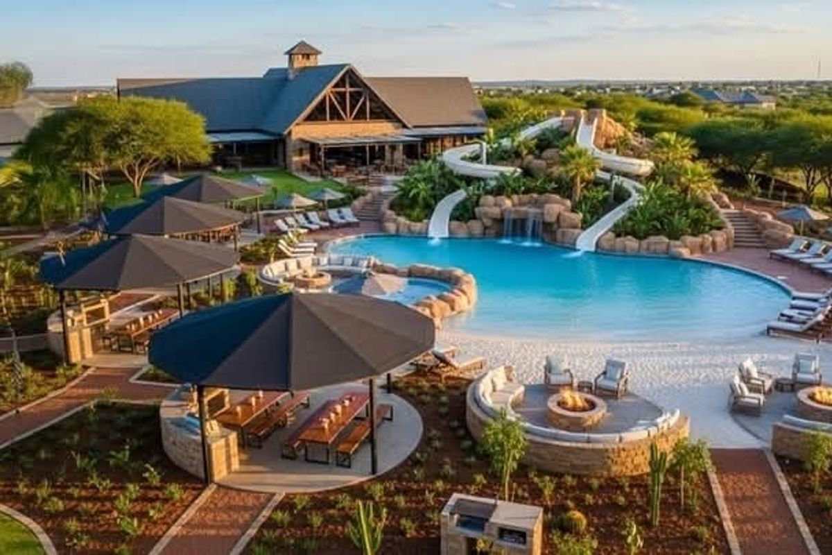 Expansive resort-style pool area featuring water slides, rock features, multiple fire pits, and covered outdoor entertainment spaces within a beautifully landscaped setting.