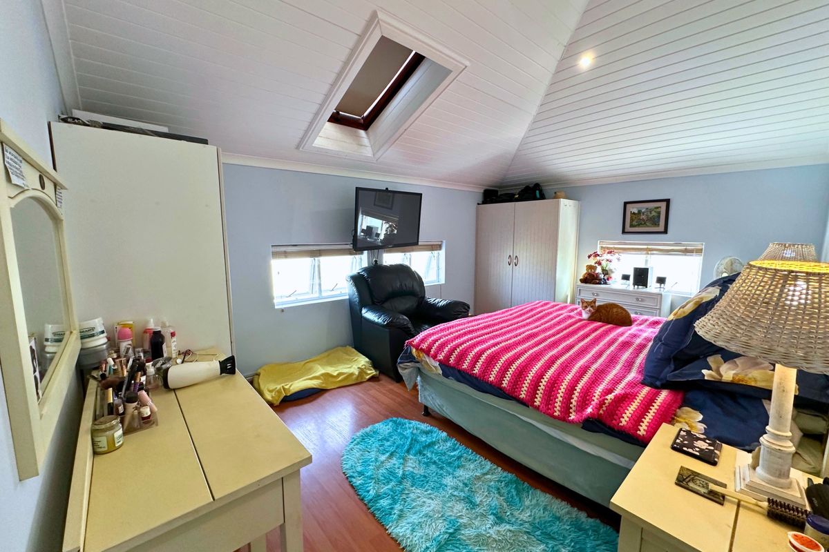 A bedroom featuring a vaulted tongue and groove ceiling with a skylight, timber-look flooring, and recessed lighting.