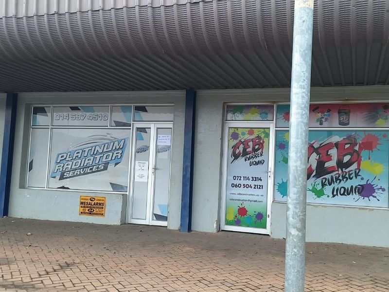 Commercial storefront featuring large glass display windows, aluminum framing, and a covered walkway entrance, suitable for retail or service-based business operations.
