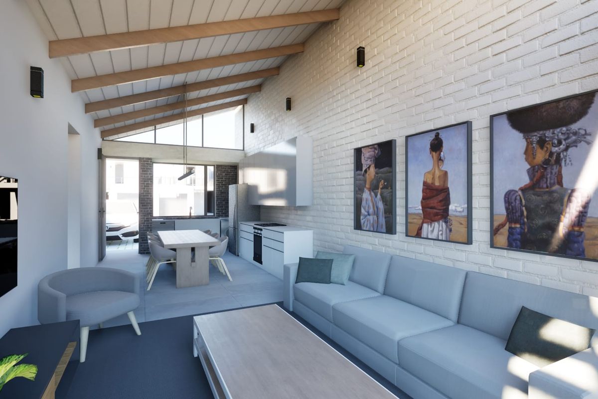 Modern open-plan living and kitchen area featuring high vaulted ceilings with exposed timber beams and a striking painted brick feature wall.