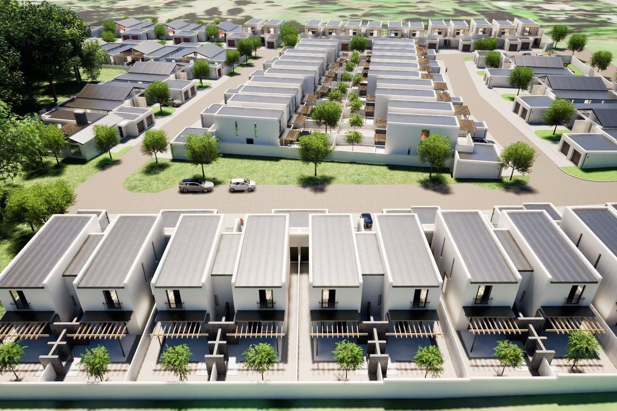 An aerial view of a modern townhouse development featuring uniform architectural design, private patios with pergolas, and landscaped communal areas.