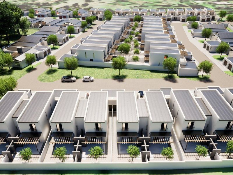An aerial view of a modern townhouse development featuring uniform architectural design, private patios with pergolas, and landscaped communal areas.