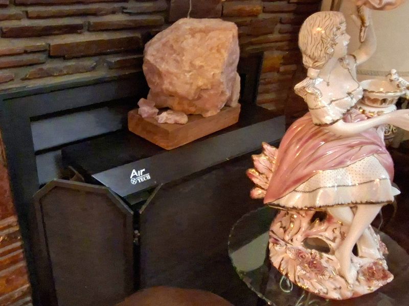 A close-up view of a brick fireplace featuring a built-in fireplace insert.