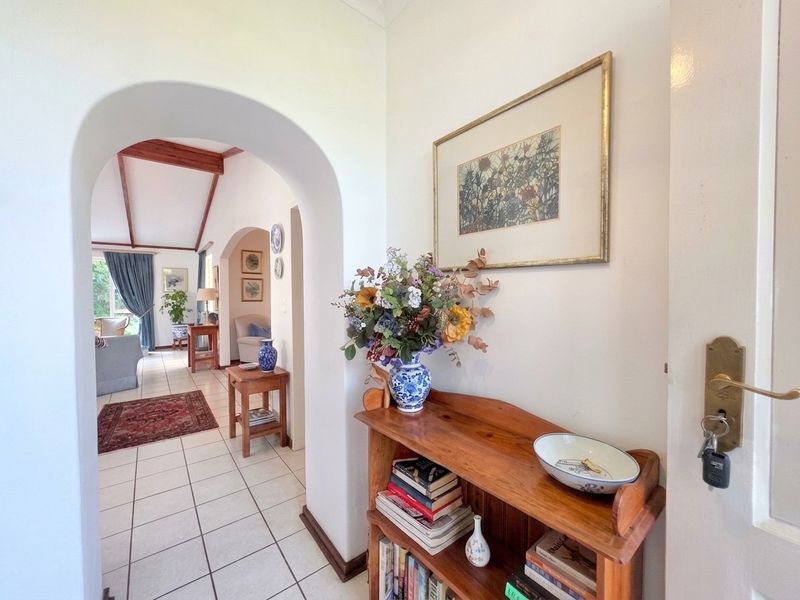 Welcoming entrance hall featuring arched architectural detailing and tiled flooring, providing a seamless transition into the open-plan living area.