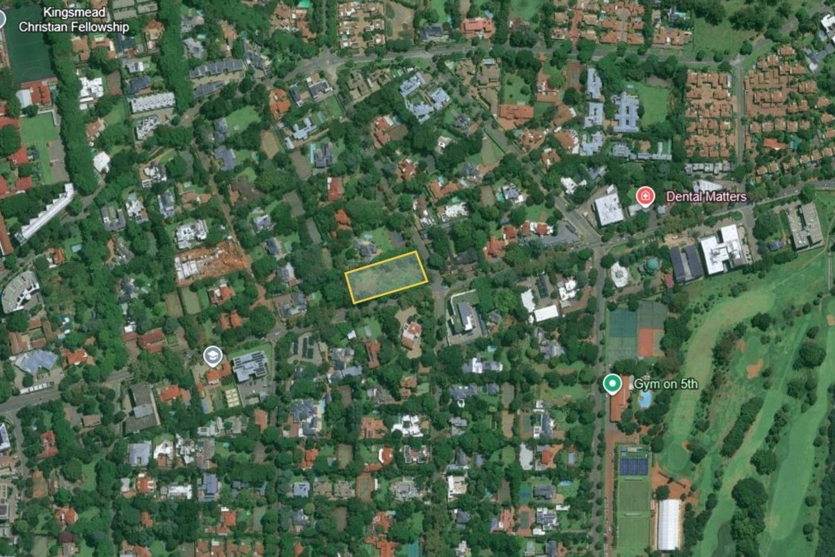 Aerial view of a vacant land parcel located in a well-established commercial and residential area.