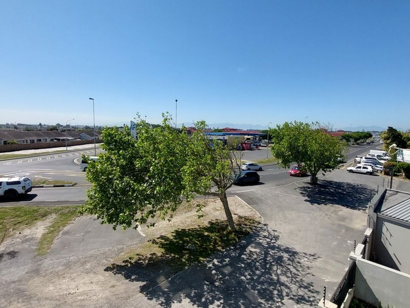 Elevated view overlooking the surrounding neighbourhood, street intersection, and local infrastructure.