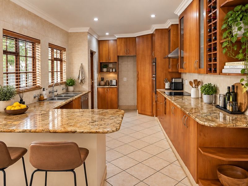 A well-maintained kitchen featuring warm wooden cabinetry, granite countertops, integrated appliances, and a functional layout with ample storage and workspace.
