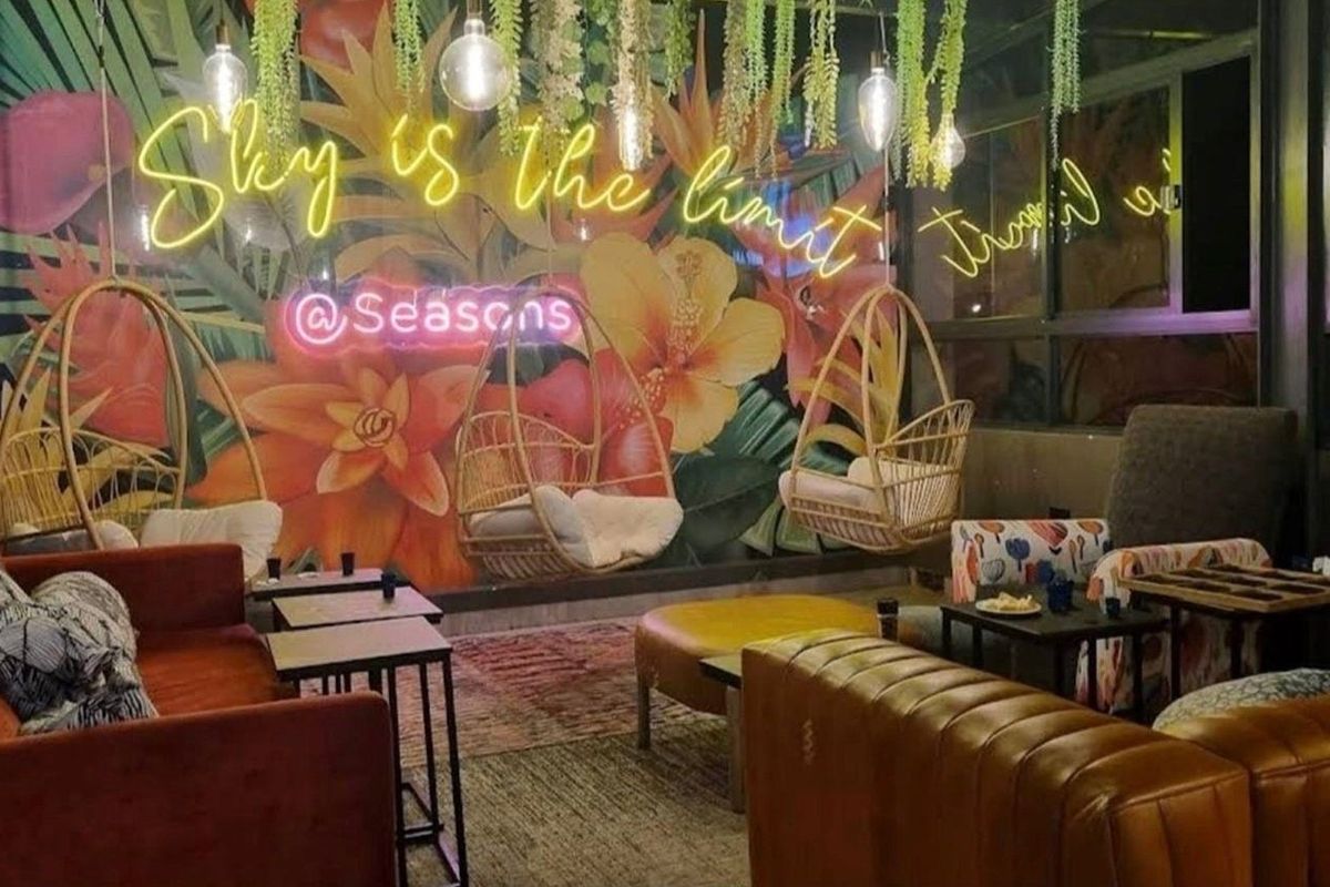 A lounge area featuring decorative wall art and ambient lighting, suitable for social gatherings or commercial hospitality use.
