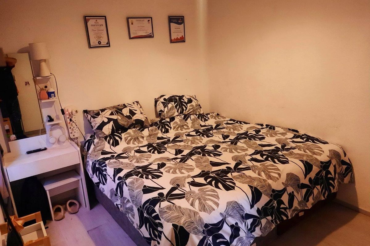 A standard bedroom featuring neutral wall finishes and laminate flooring, suitable for a comfortable sleeping space.