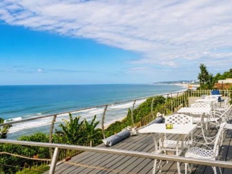 Spacious elevated timber deck featuring a stainless steel balustrade and panoramic ocean views, perfect for outdoor entertaining.