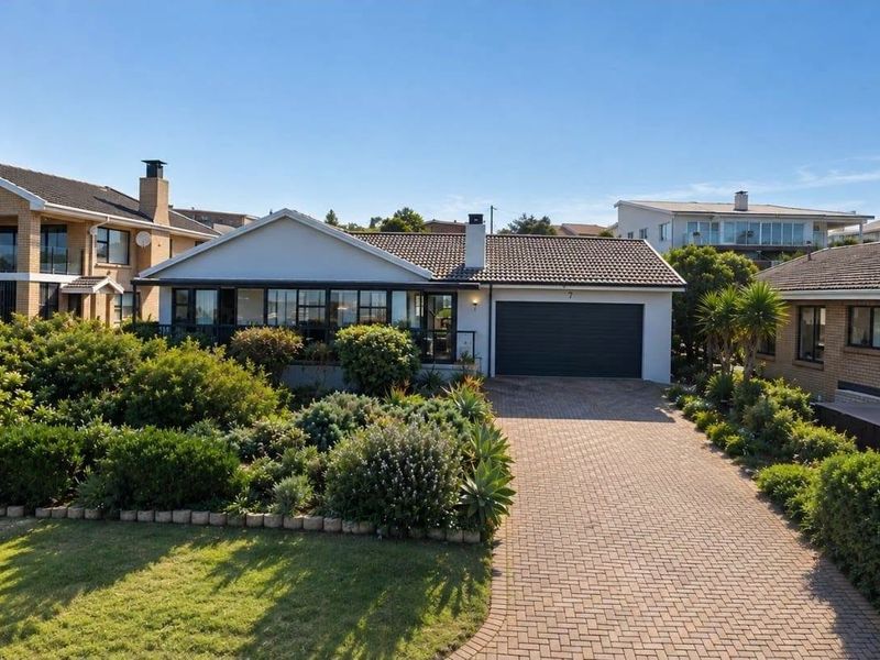 A well-maintained single-story residence featuring a paved driveway, double garage, and established landscaped garden in a quiet residential setting.