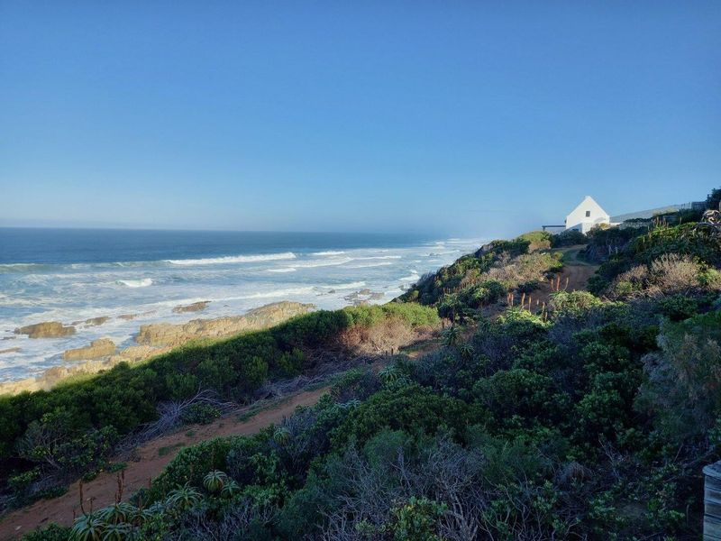 A scenic coastal view overlooking the ocean and rugged shoreline, showcasing the natural landscape and proximity to the sea.