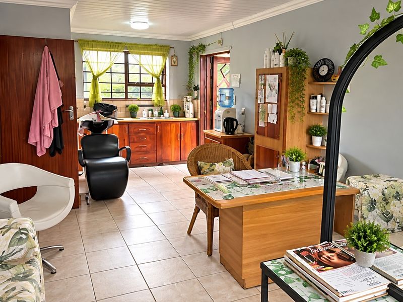 A functional utility space featuring tiled flooring, built-in wooden cabinetry, and a sink, currently utilized as a salon area.