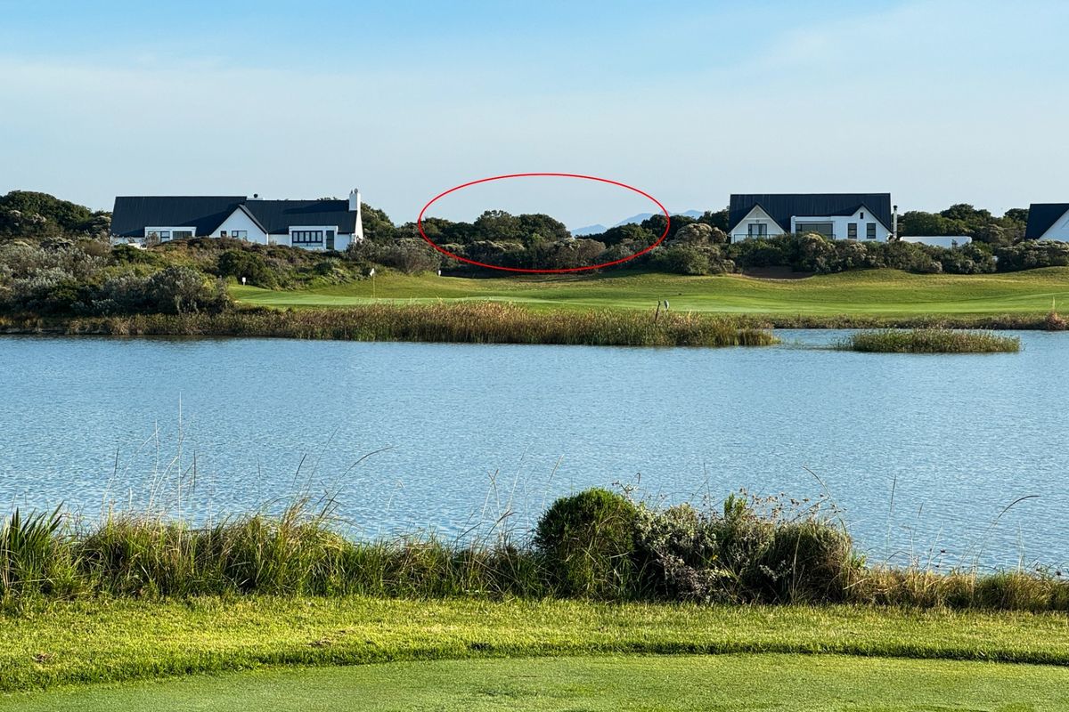 A scenic view of a lake and golf course landscape, highlighting the natural surroundings and proximity to established residential properties.