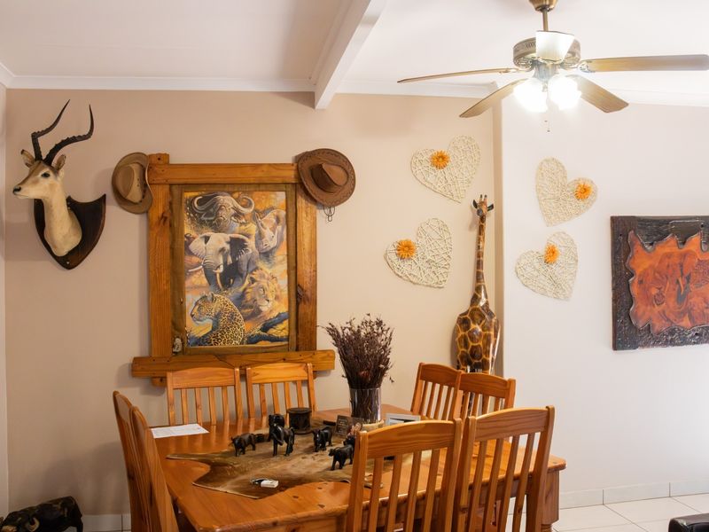 A dining room area featuring a ceiling fan and tiled flooring, providing a functional space for family meals.