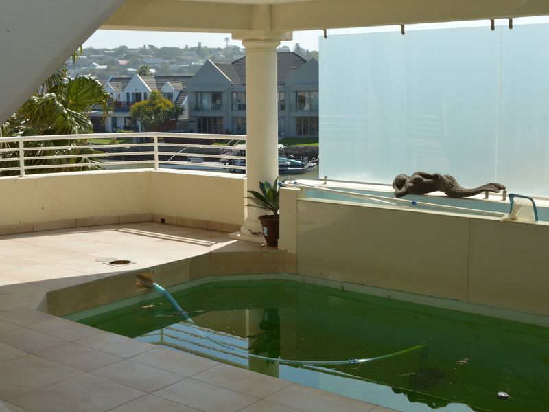 Covered patio area featuring a private swimming pool with views of the surrounding neighborhood.