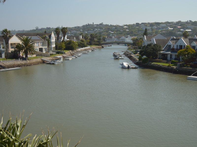 A scenic elevated view overlooking a residential canal system with private jetties and waterfront properties.