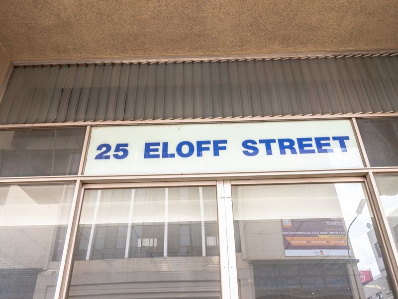 Front facade of the commercial property located at 25 Eloff Street, featuring large glass display windows and prominent building signage.
