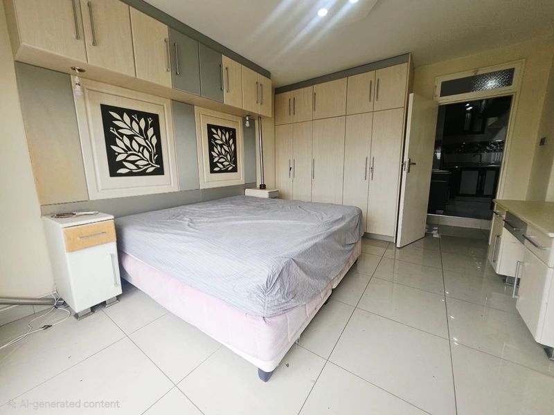 A bedroom featuring extensive built-in cabinetry, overhead storage units, and light-colored tiled flooring, offering ample storage space.