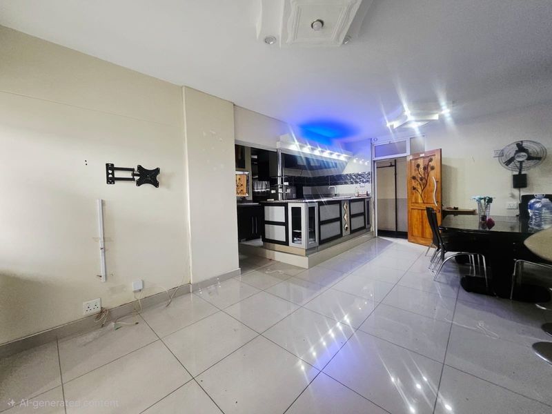 Open plan living and kitchen area featuring tiled flooring, recessed lighting, and a central kitchen island with built-in cabinetry.