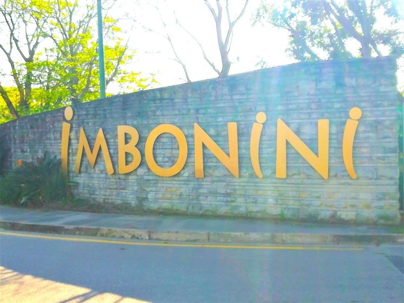 Entrance signage for Imbonini industrial park featuring a stone boundary wall.