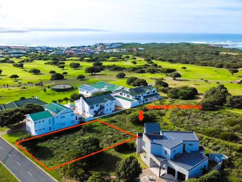 Aerial view of a vacant residential land plot situated in a coastal estate, adjacent to a golf course and established residential properties.