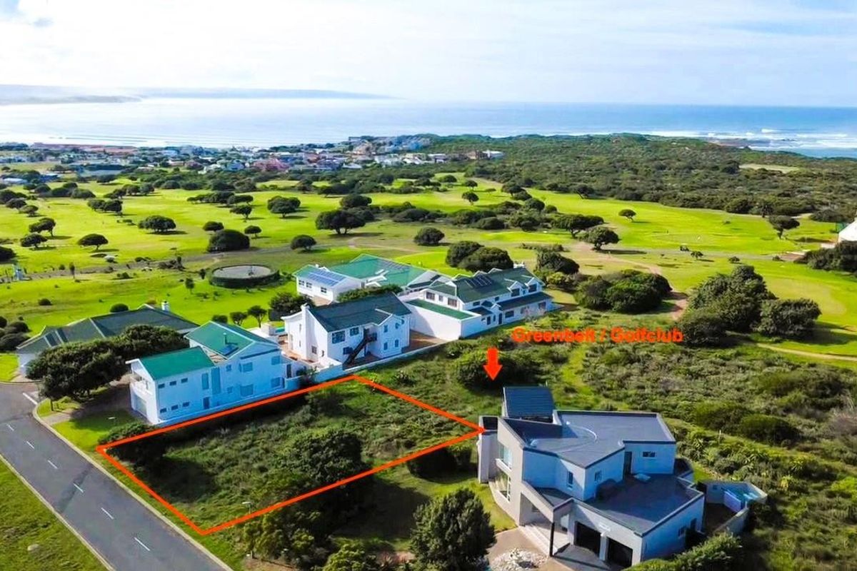 Aerial view of a vacant residential land plot situated in a coastal estate, adjacent to a golf course and established residential properties.