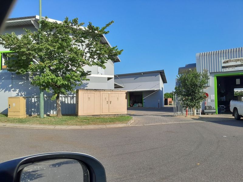 Exterior view of an industrial property complex featuring warehouse units with paved access and utility infrastructure.