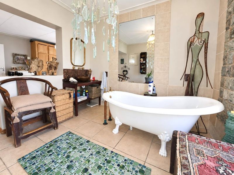 A bathroom featuring a classic clawfoot bathtub, tiled wall accents, and a vanity basin, creating a unique and character-filled space.