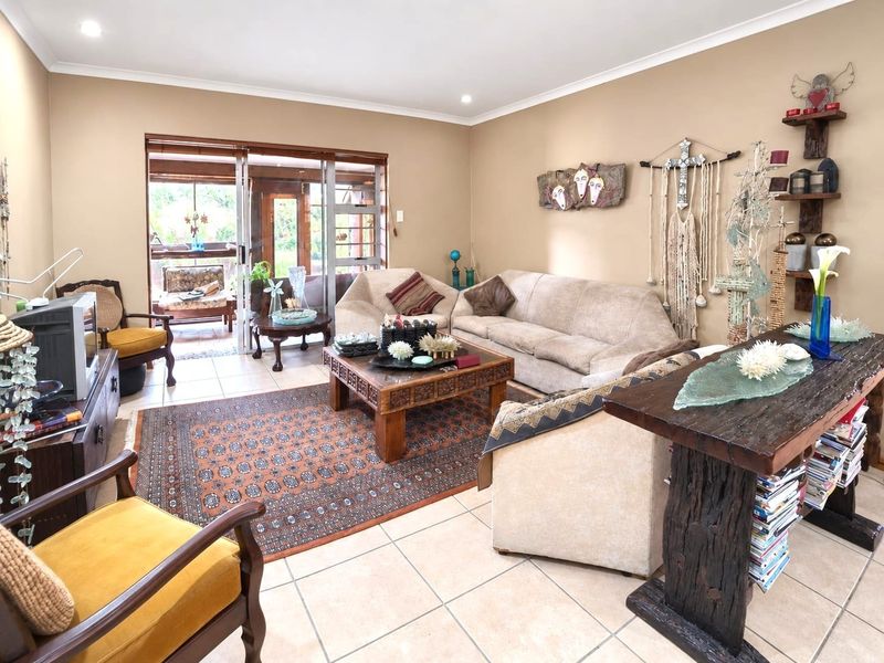 Spacious living room featuring tiled flooring, recessed lighting, and large sliding glass doors providing direct access to the outdoor patio area.