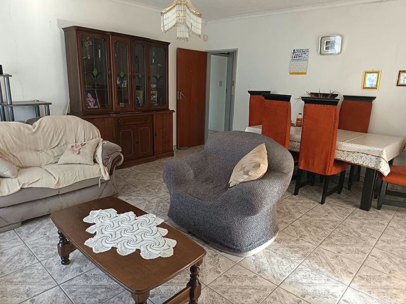 Open plan living and dining area featuring tiled flooring and neutral wall finishes, providing a functional space for family living.