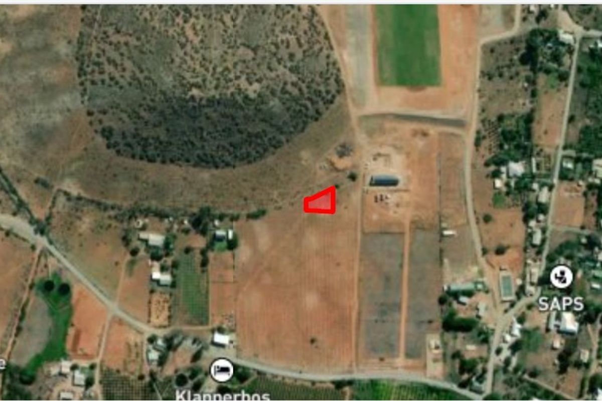 An aerial satellite view showing the location of the vacant residential land plot within the surrounding neighborhood.