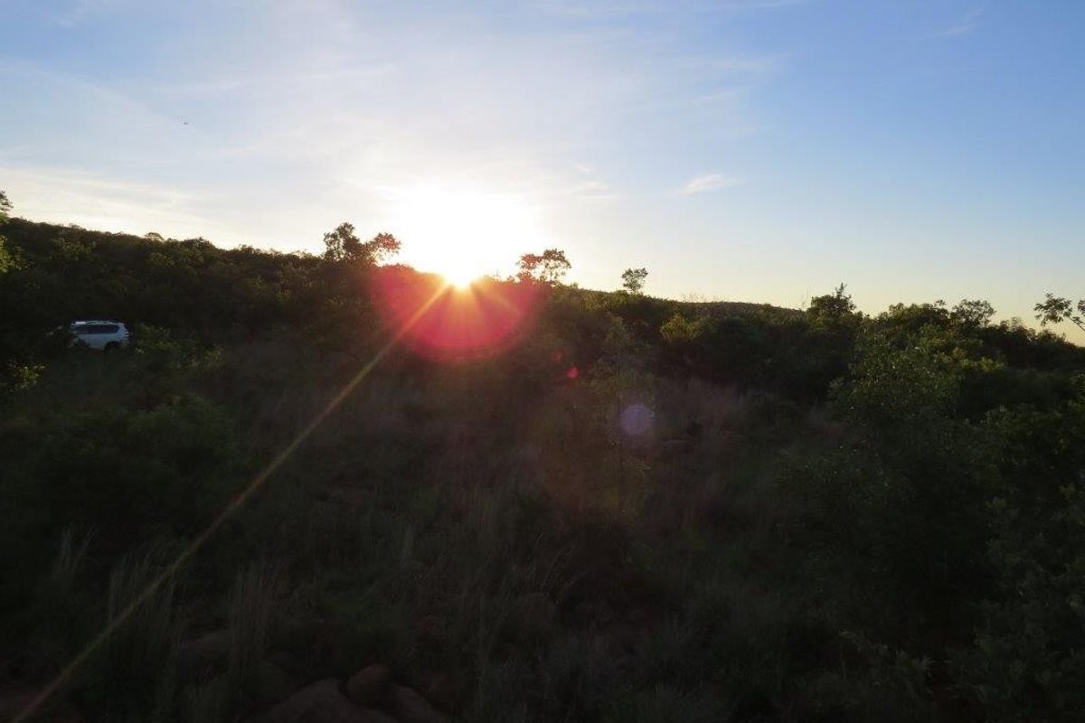 A scenic view of the natural landscape at sunset, showcasing the undeveloped terrain of the residential vacant land.