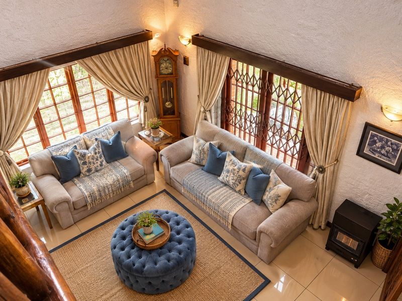 Spacious living room featuring high vaulted ceilings, tiled flooring, and large windows with security gates, creating a bright and airy atmosphere.