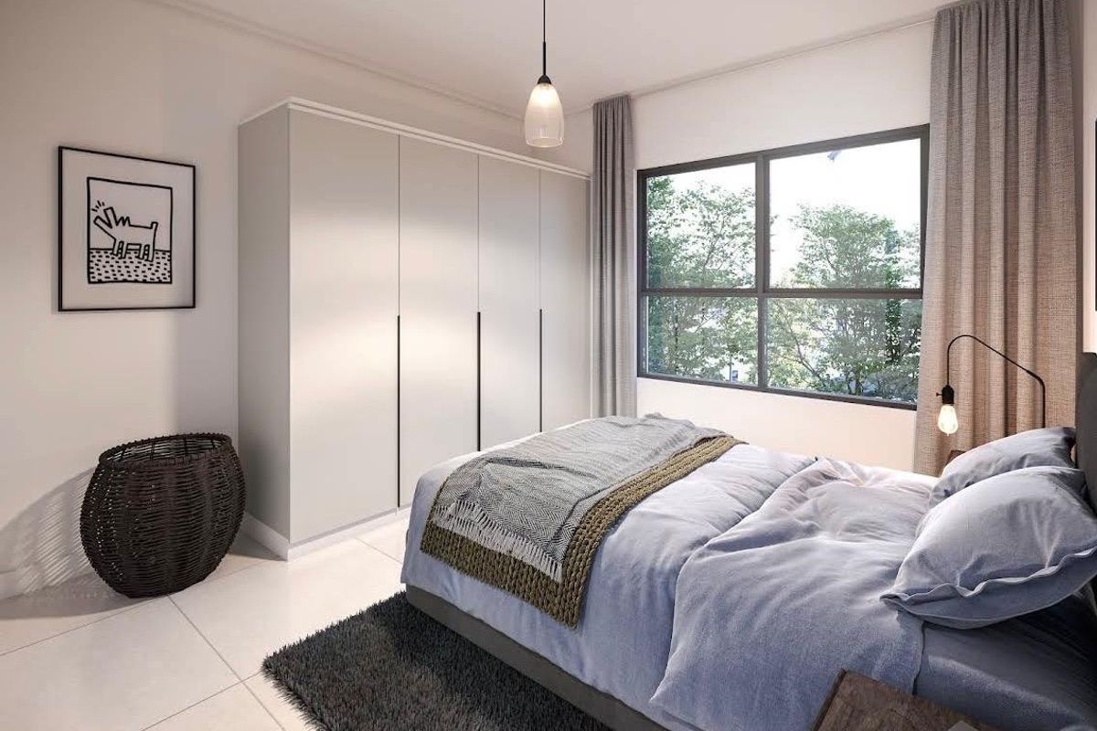 Modern bedroom featuring a large window, neutral tiled flooring, and a sleek built-in wardrobe with minimalist hardware.