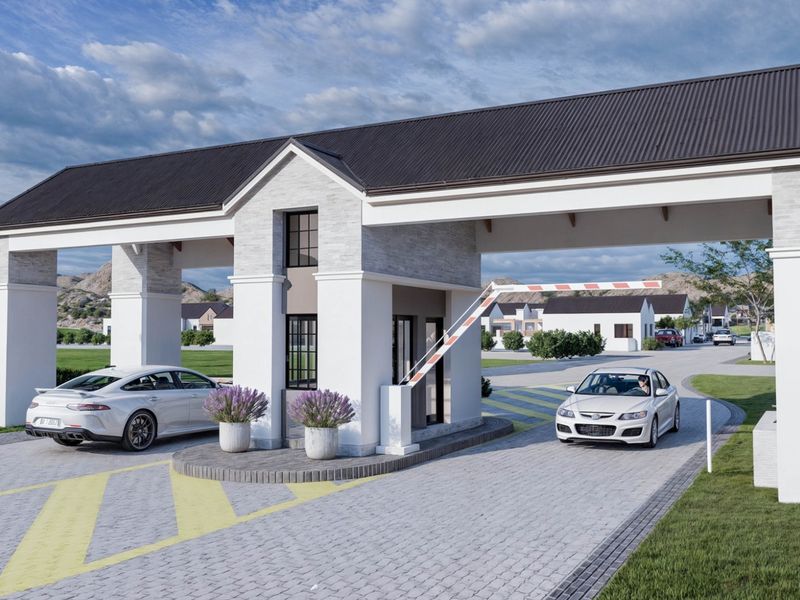 A modern, well-maintained security gatehouse entrance for the retirement village, featuring a boom gate and paved driveway access.