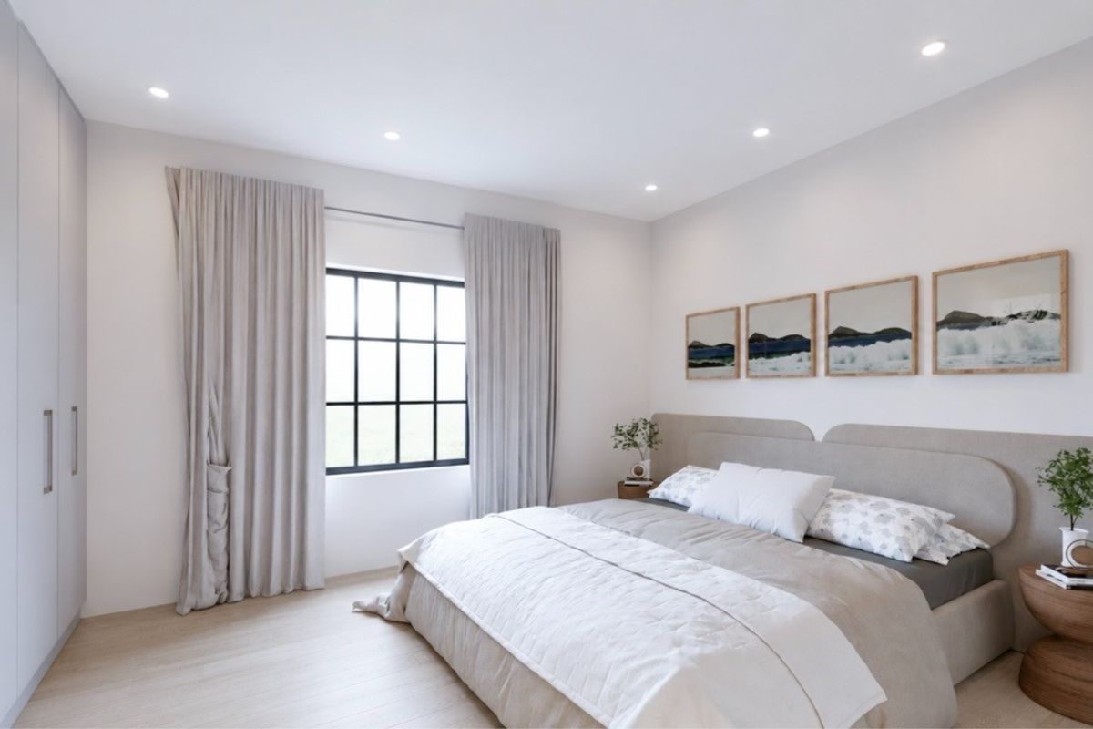 A modern, well-lit bedroom featuring neutral tones, built-in wardrobe storage, and a large grid-pattern window.