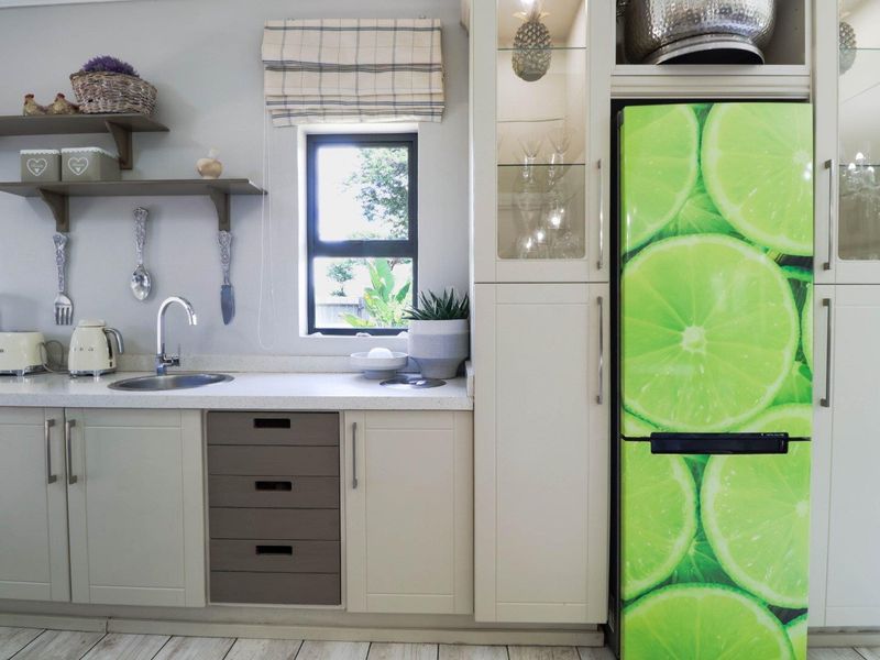 A well-maintained kitchen featuring neutral cabinetry, stone countertops, an undermount sink, and integrated storage solutions with a bright, functional layout.
